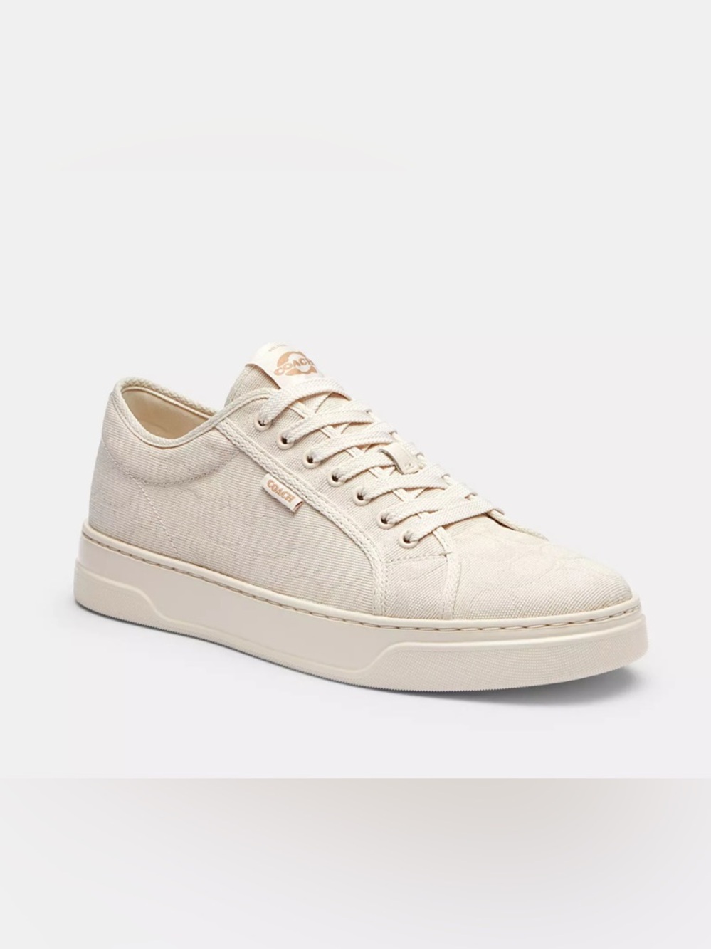 Coach women’sCream Canvas Low-Top Sneaker with Subtle Logo